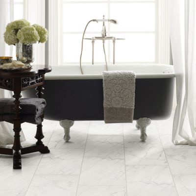 tile flooring in an elegant bathroom with tub and large windows